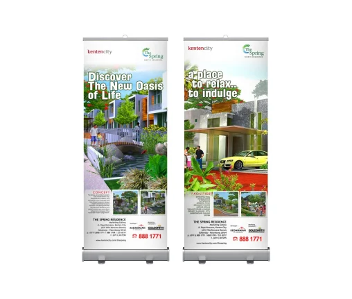 Desain roll banner ganda The Spring Kenten City Palembang menampilkan konsep hunian hijau asri dan fasilitas perumahan eksklusif dengan tata letak profesional.